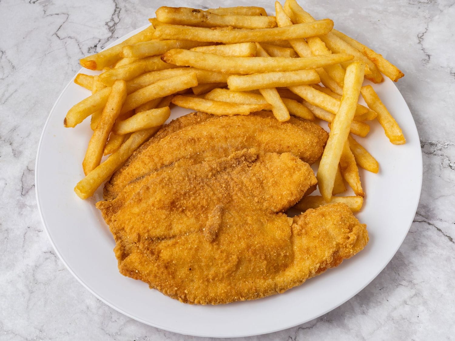 Two pieces of fried tilapia with fries at Mayo Grill Aurora